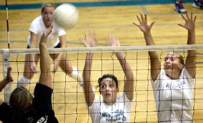 
Seniors Caitlin Crimp, left, and Tabi Mabrey, right, going up for a block at practice, are among those returning for LC. 
 (Joe Barrentine / The Spokesman-Review)