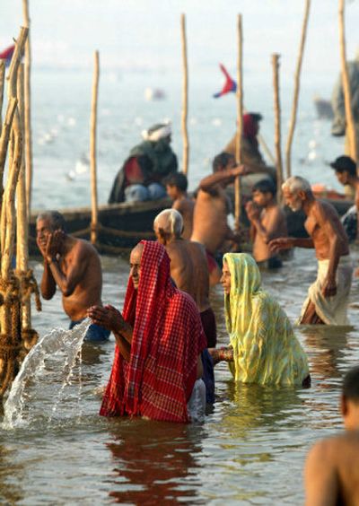 
Hindus pray after taking a dip Monday in the Ganges River in Allahabad, India. Millions of Hindus are taking part in the Ardh Kumbh Mela festival, but thousands of Hindu holy men have threatened to boycott, saying the river is  too polluted. 
 (Associated Press / The Spokesman-Review)