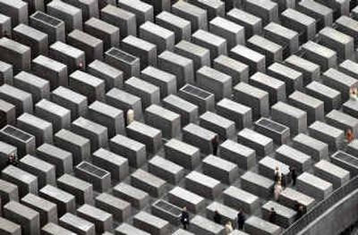 
People walk inside the Memorial to the Murdered Jews of Europe after the opening ceremony in Berlin on Tuesday. 
 (Associated Press / The Spokesman-Review)
