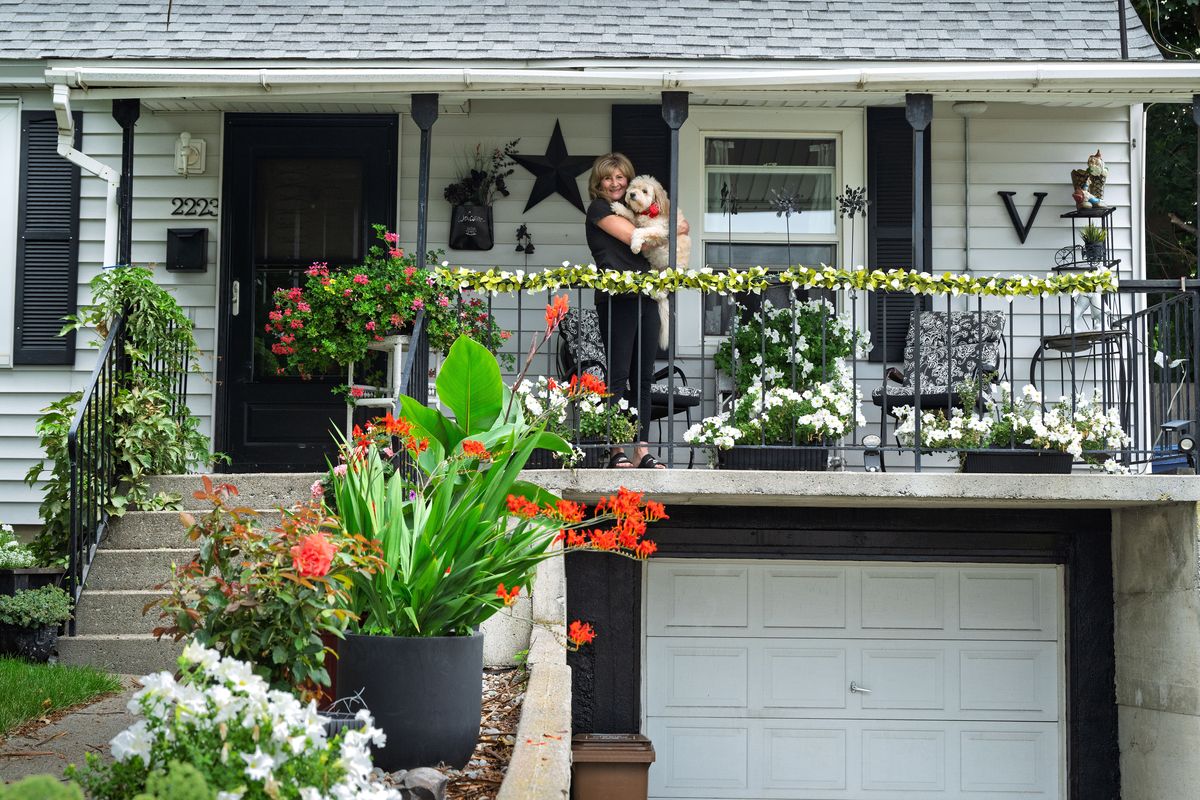 Marcia Via’s Hillyard front porch and yard are filled with inviting flowering planters.  (COLIN MULVANY/THE SPOKESMAN-REVIEW)