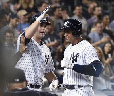 Brian McCann, left, greets Alex Rodriguez after A-Rod homered to give Yankees 4-3 lead. (Associated Press)