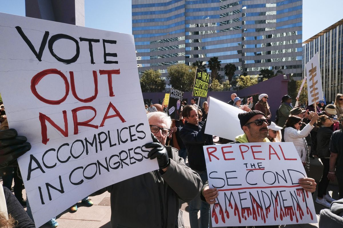 Protesters join in on a grassroots movement during a rally against gun violence Monday, Feb. 19, 2018, in downtown Los Angeles. Hundreds of sign-carrying, chanting protesters have converged on a downtown Los Angeles park, demanding tougher background checks and other gun-safety measures following the deadly school shooting in Florida. (Richard Vogel / AP)