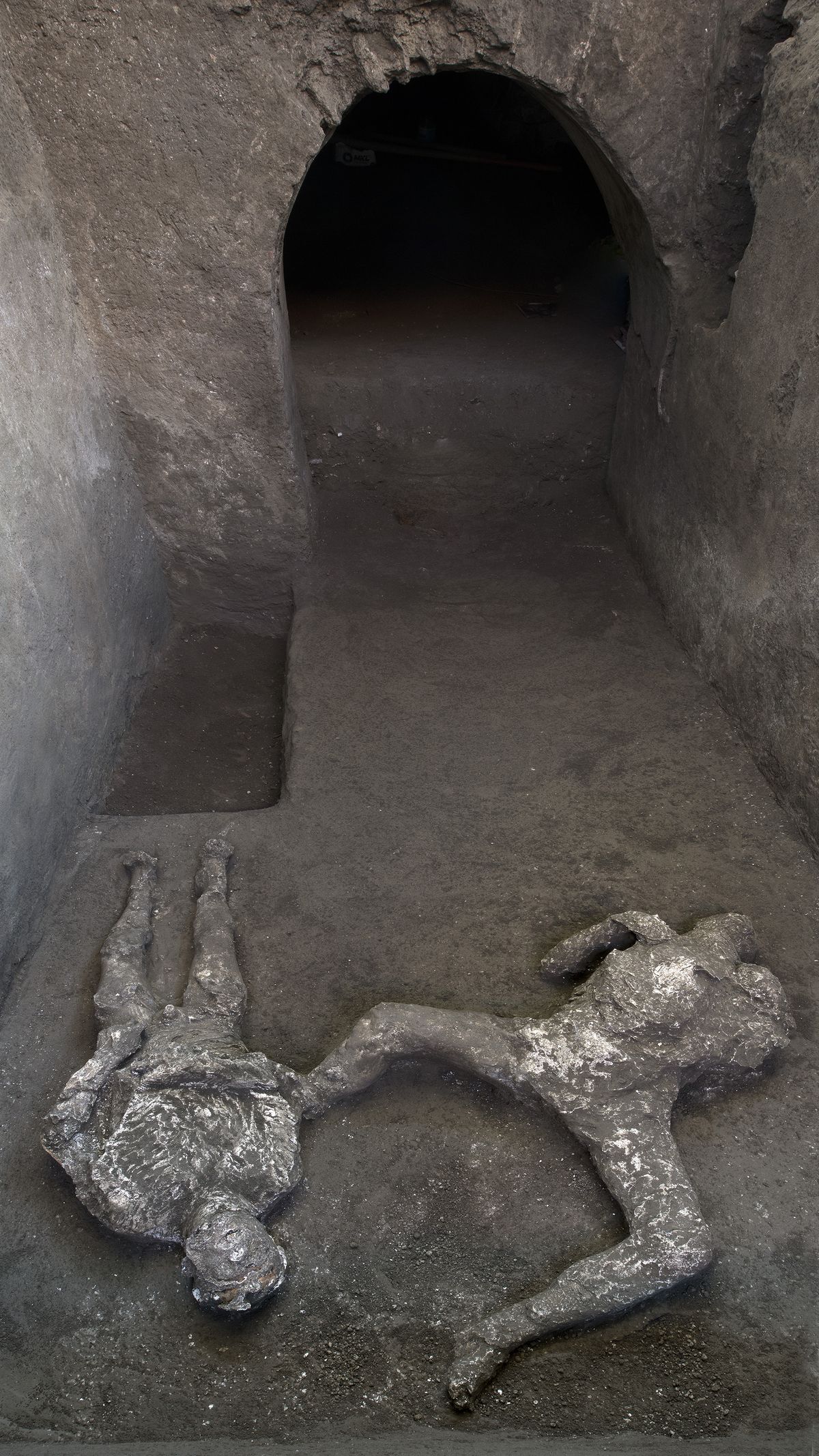 The casts of what are believed to have been a rich man and his male slave fleeing the volcanic eruption of Vesuvius nearly 2,000 years ago, are seen in what was an elegant villa on the outskirts of the ancient Roman city of Pompeii destroyed by the eruption in 79 A.D., where they were discovered during recents excavations, Pompeii archaeological park officials said Saturday, Nov. 21, 2020.  (HOGP)