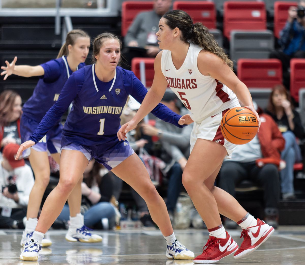 WSU guard Charlisse Leger-Walker, right, drives around Washington guard Hannah Stines in the first half on Sunday, Dec. 10, 2023 at Beasley Coliseum in Pullman, Wash.  (Geoff Crimmins/The Spokesman-Review)
