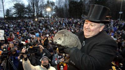 
Punxsutawney Phil, the weather predicting groundhog, is held by his handler Bill Deeley in front of an announced crowd of 14,000 in Punxsutawney, Pa., on Thursday 
 (Associated Press / The Spokesman-Review)