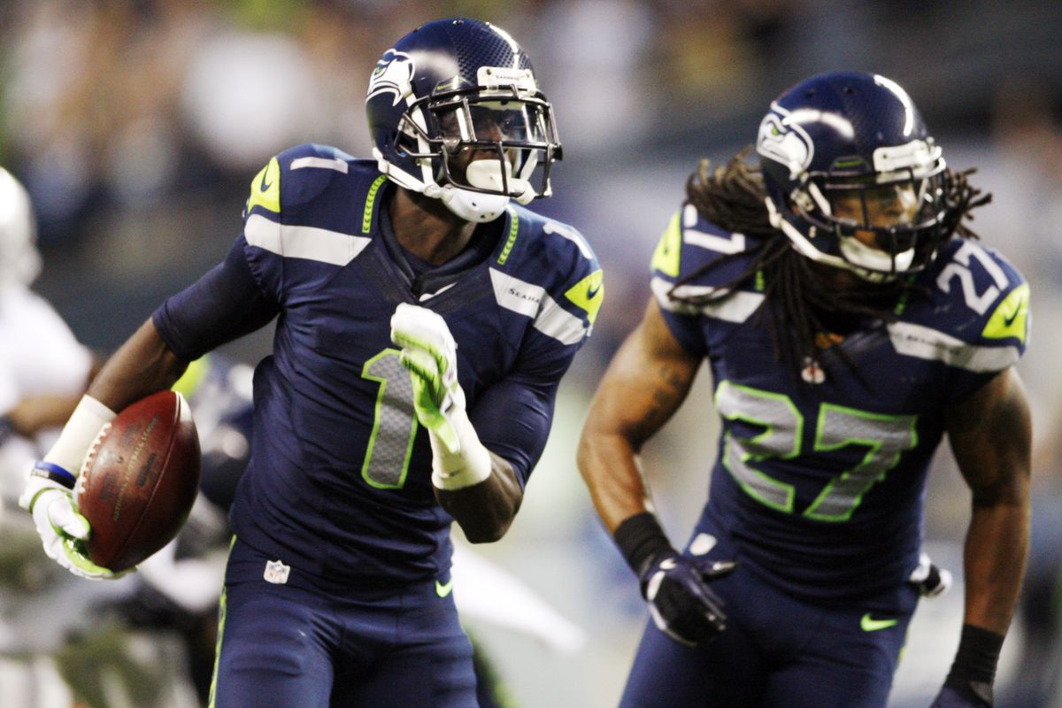 Seahawks’ Jeremy Lane returns an interception against the Oakland Raiders in the first half. (Associated Press)