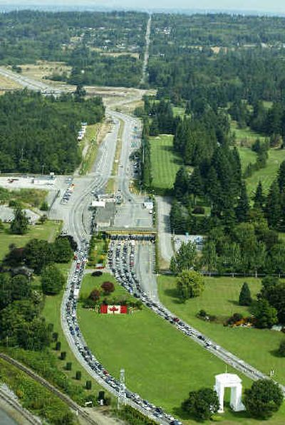 
The Peace Arch, lower right, is shown from the air at the U.S.-Canada border crossing at Blaine, Wash., Friday. The view is from a UH-60-A Blackhawk helicopter used by the Immigration and Customs Enforcement Office of Air and Marine Operations, which began operations Friday along the U.S.-Canada border. 
 (Associated Press / The Spokesman-Review)