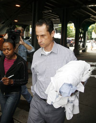 Anthony Weiner takes his laundry to a cleaner in Queens, N.Y., on Saturday. (Associated Press)