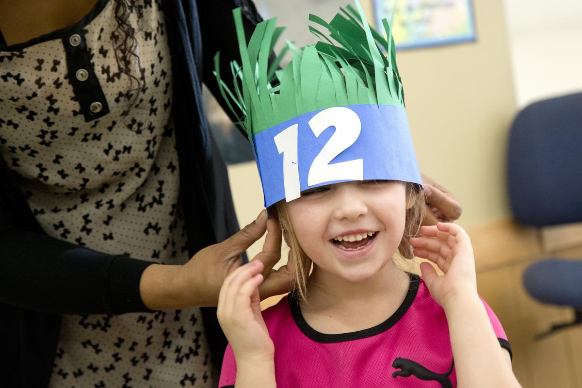 Kindergartner Josie Wangsgard’s paper hat falls around her ears during a classroom Super Bowl party Thursday at Spokane’s Jefferson Elementary School. Many of the children are fans of the Seattle Seahawks and made crafts to wear and use Sunday during the Super Bowl. (Jesse Tinsley)