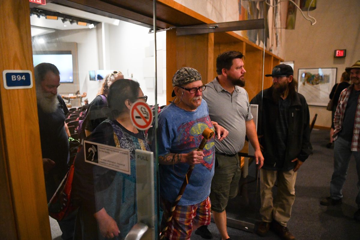 Alfredo LLamedo, center, exits the Spokane City Council chambers with help from friends and loved ones after a meeting on Monday, July 15, 2019, in Spokane. (Tyler Tjomsland / The Spokesman-Review)