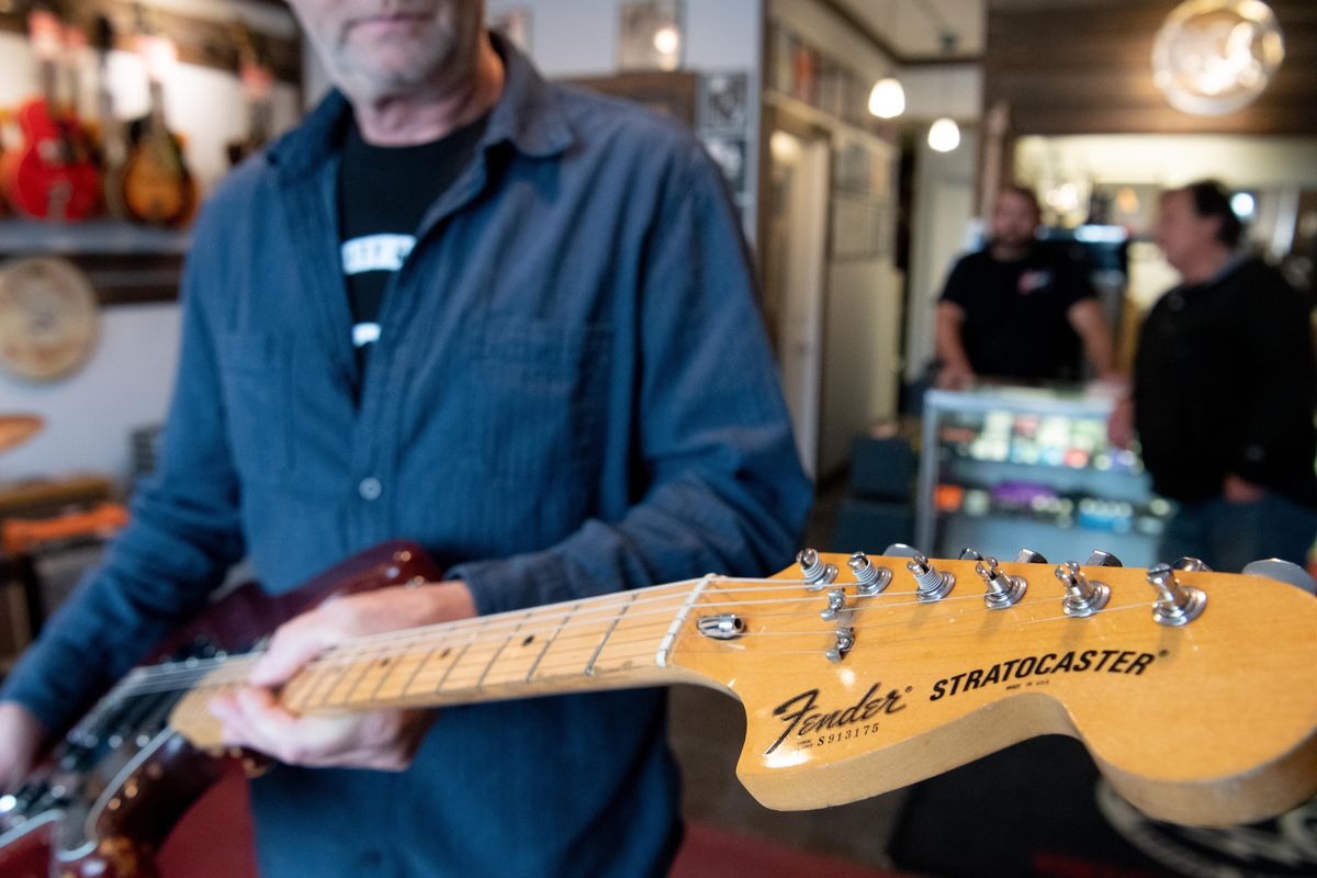 Tom Ramsey of River City Guitars in Spokane holds a 1979 Fender Stratocaster guitar that belonged to Jimmy Page of Led Zeppelin fame Wednesday, Oct. 16, 2019. The guitar shop has a price of $19,999 of the heavily worn axe. Page is notoriously frugal and unlikely to part with his guitars, making this one fairly rare. Page played the guitar in the Coverdale/Page era of the 1980s. (Jesse Tinsley / The Spokesman-Review)