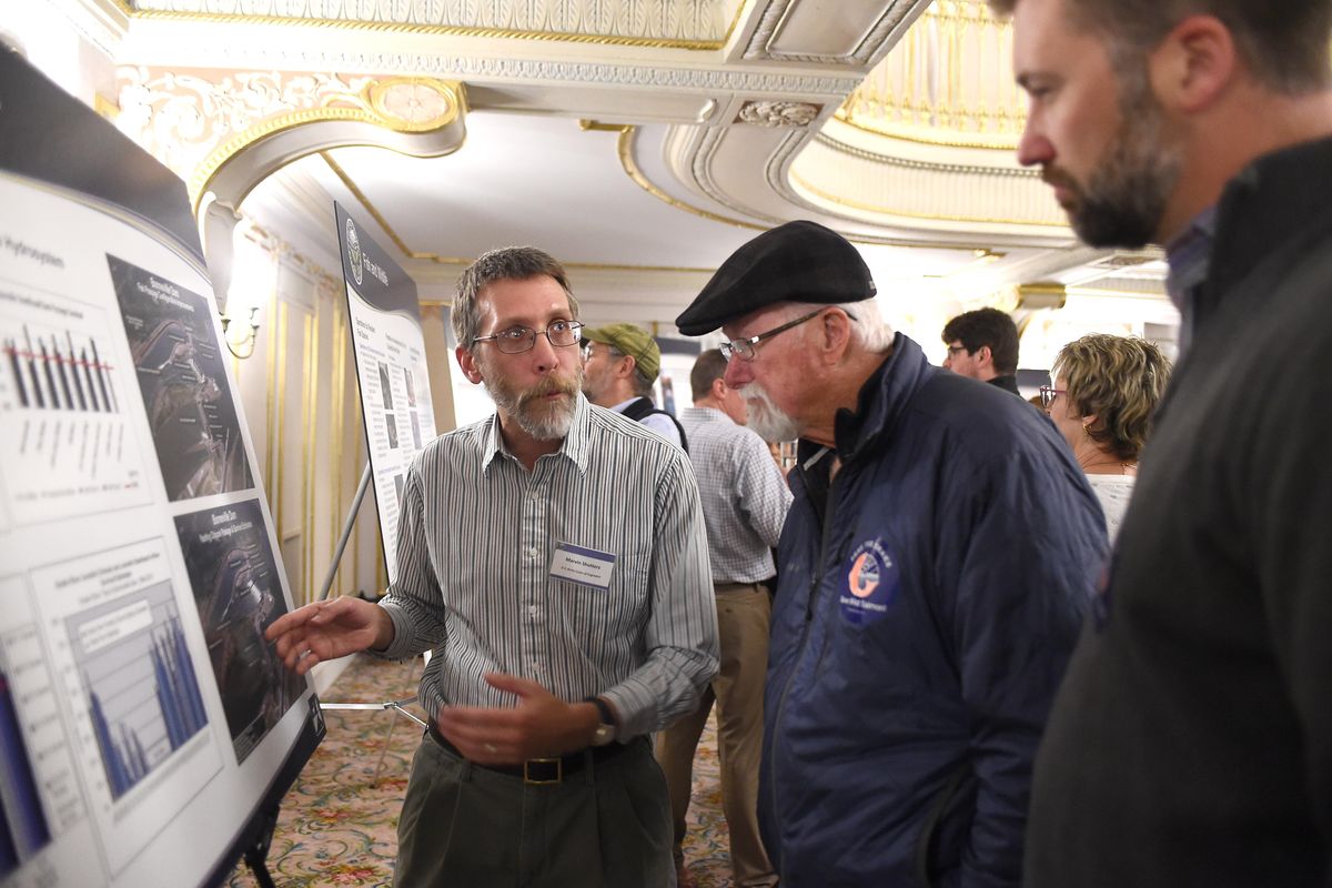 Marvin Shutters, a fish expert with the Army Corps of Engineers, speaks with Fay Mills, center, and his son Josh Mills, right, about fish mortality in dams during a regional meeting about salmon policy at the Davenport Hotel, Monday, Nov. 14, 2016. Josh Mills, with the group Wild Steelhead Coalition, spoke at a rally for dam breaching advocates before the meeting began. (Jesse Tinsley / The Spokesman-Review)