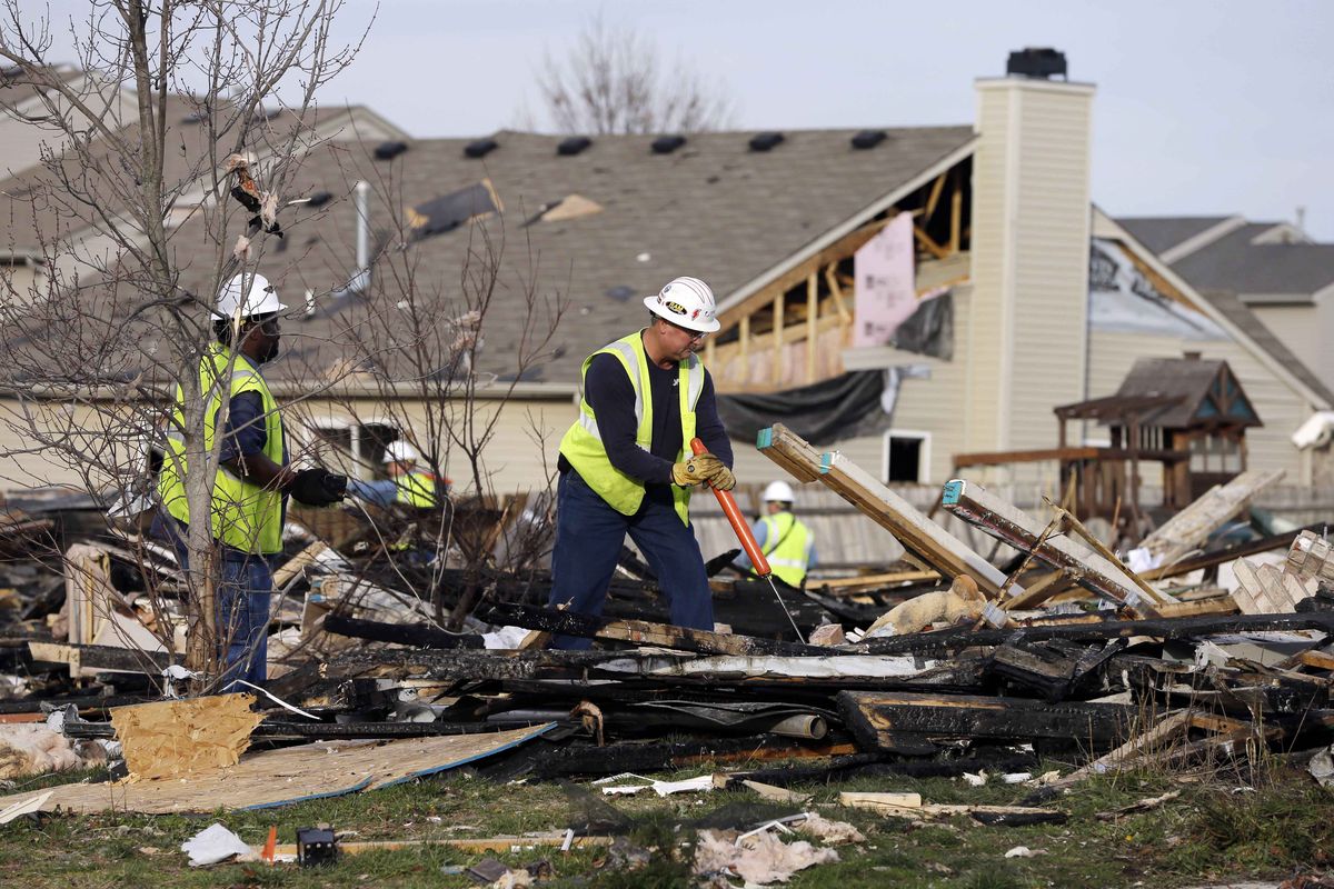 Citizens Energy Group workers work at the site of a home explosion Sunday, Nov. 11, 2012, in Indianapolis. Nearly three dozen homes were damaged or destroyed, and seven people were taken to a hospital with injuries, authorities said Sunday. The powerful nighttime blast shattered windows, crumpled walls and could be felt at least three miles away. (Darron Cummings / Associated Press)