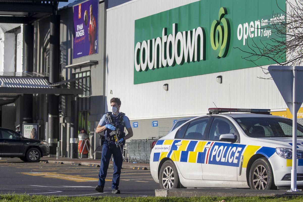 Armed police stand outside a supermarket in Auckland, New Zealand, Saturday, Sept. 4, 2021. New Zealand authorities say they shot and killed a violent extremist, Friday Sept. 3, after he entered a supermarket and stabbed and injured six shoppers. Prime Minister Jacinda Ardern described Friday