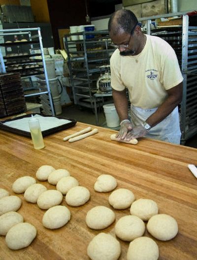 
At The Great Harvest Bread Co., bakers use whole-grain dough to make ribbon bread. 
 (File / The Spokesman-Review)