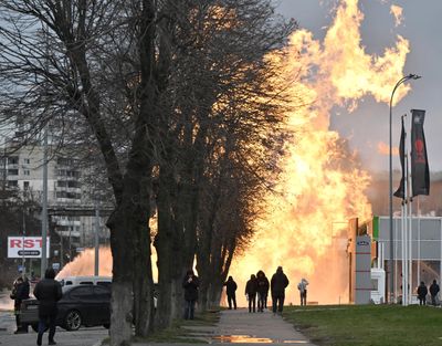 People look at a fire after a missile strike in Kyiv, Ukraine, on Tuesday.  (Genya Savilov/AFP)