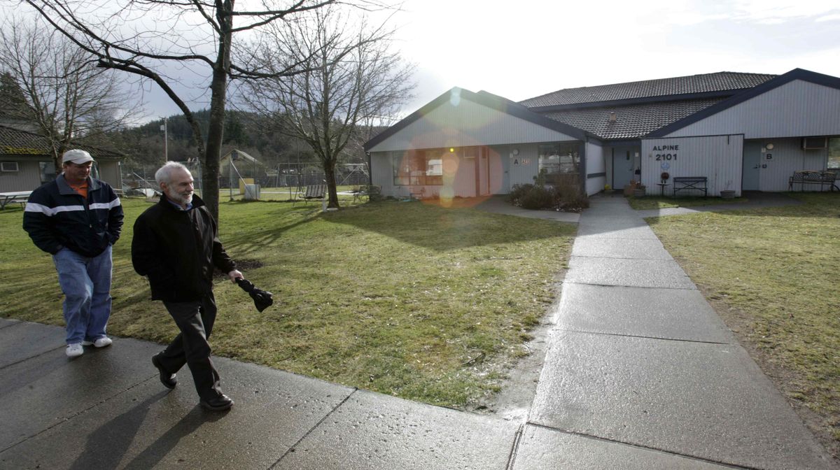 Perry Patson, left, a community program manager, walks with assistant superintendent Alan McLaughlin  on the campus of the Rainier School on Feb. 3.