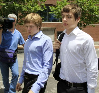  Tim Foley, 20, left, and his brother Alex, 16, leave court Thursday after a bail hearing for their parents, who are accused of spying.  (Associated Press)