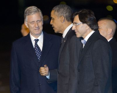 President Barack Obama is greeted by Belgian King Philippe, left, and Belgian Prime Minister Elio Di Rupo upon his arrival on Air Force One at Brussels International Airport on Tuesday. (Associated Press)