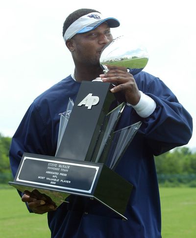 In this 2004 photo, Steve McNair kisses the Associated Press MVP trophy he was awarded.  (Associated Press / The Spokesman-Review)