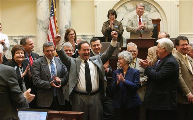 Non-returning Representatives gathered in the front of the Idaho House for photos. Erik Simpson (R-Idaho Falls), arms raised, has served two terms. The House finished up business and adjourned on Thursday, March 29, 2012 in Boise, Idaho.

 (AP/Idaho Statesman / Katherine Jones)