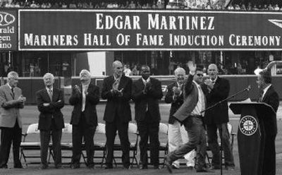 
Edgar Martinez waves Saturday as he is applauded by Mariners executives and current members of the Mariners Hall of Fame. 
 (Associated Press / The Spokesman-Review)