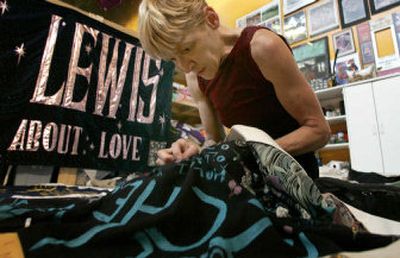 
Gert McMullin, 50, sits inside her Atlanta workshop repairing the AIDS Memorial Quilt. 