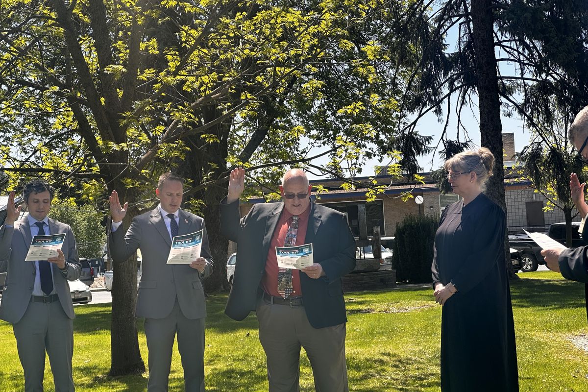 More than 10 lawyers who stood in a circle in front of the Stevens County Courthouse early Thursday afternoon, while Stevens Superior Court Judge Lech J. Radzimski read the attorney’s oath. Among them was Rep. Hunter Abell (second to left). (Monica Carrillo-Casas/The Spokesman-Review)