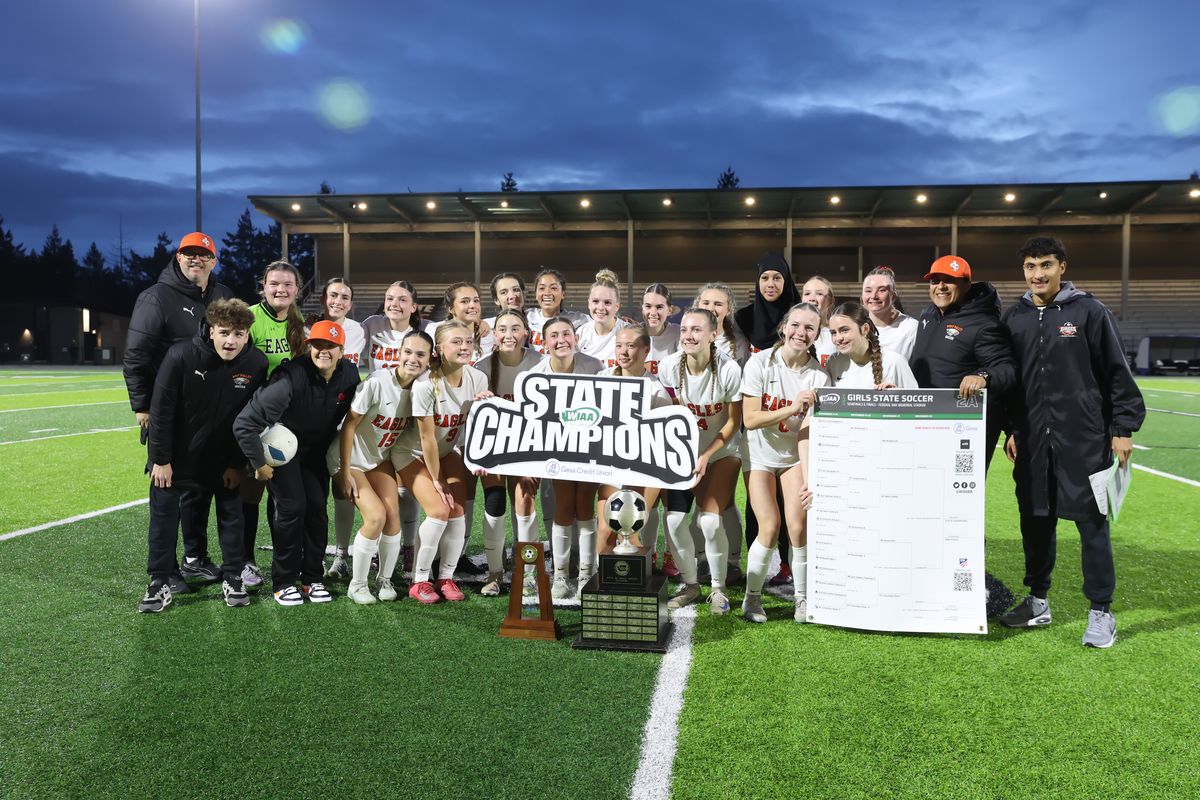 The West Valley girls soccer team poses with the State 2A championship trophy after beating Columbia River 1-0 in the title game on Nov. 22, 2025 at Federal Way Memorial Stadium.  (Randy Calahen)