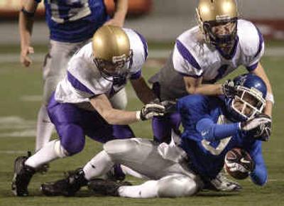 
Kris Knight, left, and Taylor Jenks of Connell send Pullman's Justin Krieger to the turf during the second quarter of a 19-7 State 2A win. Kris Knight, left, and Taylor Jenks of Connell send Pullman's Justin Krieger to the turf during the second quarter of a 19-7 State 2A win. 
 (Rajah Bose/ Rajah Bose/ / The Spokesman-Review)