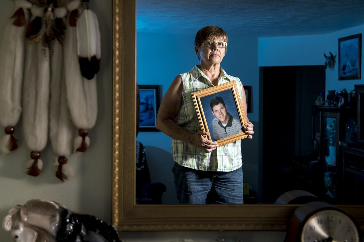 Jackie Pederson holds a photo of her son Jason, who was shot and killed in a downtown Spokane alley recently. Jason was 37 when he died. Growing up, he was a pretty clean-cut kid. He was an Eagle Scout, and his dad was his troop leader. When Jason was in his early 20s, his dad died, and Jason was the one who came home and found him. It really affected him, and he struggled with depression and alcoholism off and on throughout his adult life. (Colin Mulvany / The Spokesman-Review)