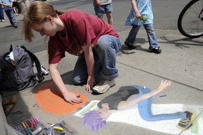 Makayla Miracle, 15, works on her skateboard and anime-inspired chalk drawing during the chalk art contest in Hillyard on Saturday. Her drawing won Best in Show at the contest. (Jesse Tinsley / The Spokesman-Review)