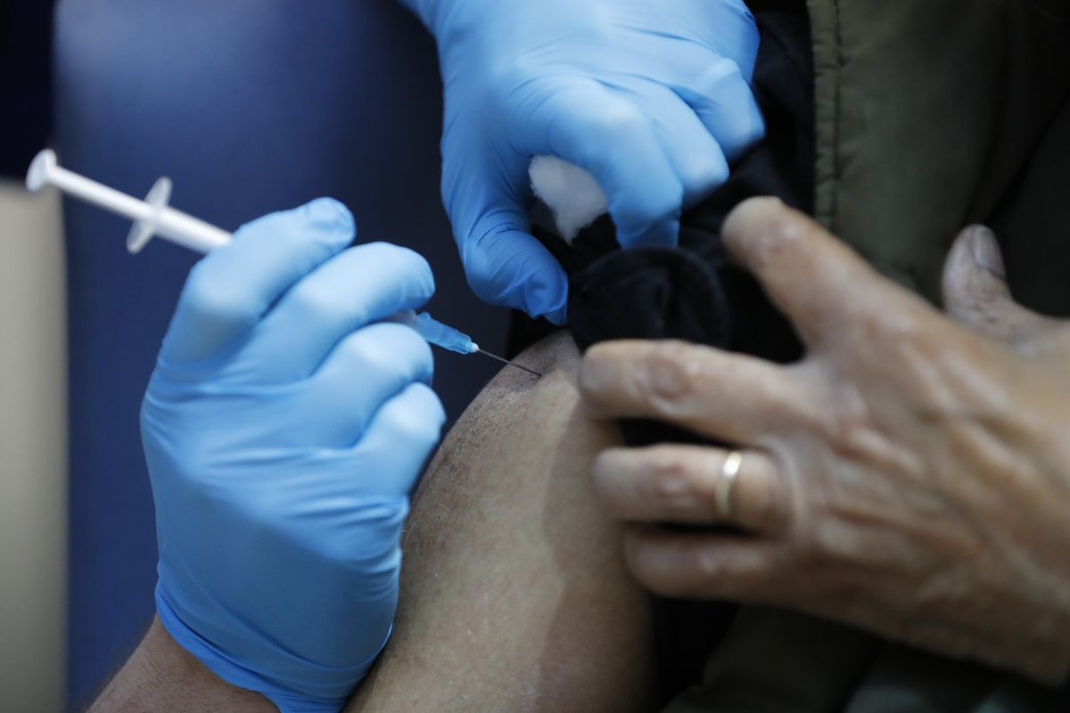 A nurse administers the Pfizer-BioNTech COVID-19 vaccine at Guy's Hospital in London, Tuesday, Dec. 8, 2020. U.K. health authorities rolled out the first doses of a widely tested and independently reviewed COVID-19 vaccine Tuesday, starting a global immunization program that is expected to gain momentum as more serums win approval.  (Frank Augstein)