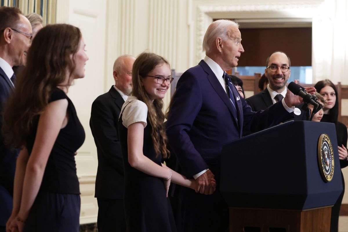 WASHINGTON, DC - AUGUST 01: U.S. President Joe Biden, holding hands with Miriam Butorin, daughter of Alsu Kurmasheva, and joined by relatives of prisoners freed by Russia, delivers remarks on the release of Wall Street Journal reporter Evan Gershkovich and former U.S. Marine Paul Whelan from Russian captivity, in the State Dining Room at the White House on August 01, 2024 in Washington, DC. The two, along with Alsu Kurmasheva, a dual U.S.-Russian citizen and Radio Free Europe journalist, and Vladimir Kara-Murza, a Washington Post columnist, and others were released in a prisoner exchange with Russia. (Photo by Alex Wong/Getty Images)  (Alex Wong)