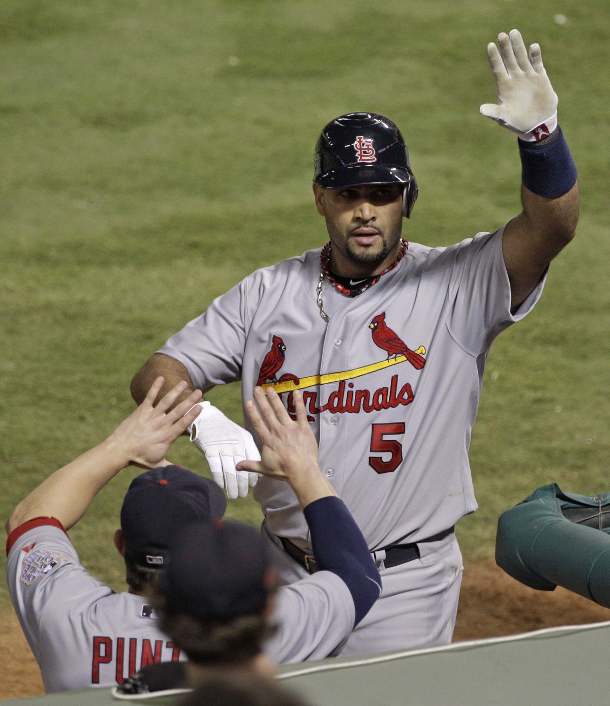 Cards’ Albert Pujols celebrates in the seventh inning, after his second of three homers. (Associated Press)