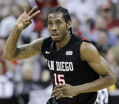 In this March 12, 2011, file photo, San Diego State’s Kawhi Leonard gestures after hitting a 3-point basket during the first half of an NCAA college basketball championship game against BYU in the Mountain West Conference tournament in Las Vegas. Nine years after Leonard helped lead San Diego State to national prominence, the Aztecs will honor the greatest player in program history by hoisting his No. 15 jersey into the rafters at Viejas Arena, high above Steve Fisher Court on Saturday, Feb. 1, 2020. (Julie Jacobson / Associated Press)