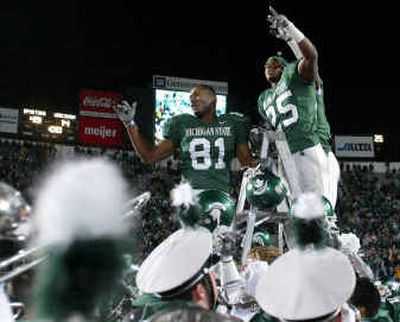 
Michigan State's Jason Randall (81) and Jason Harmon celebrate a victory over previously unbeaten Wisconsin.
 (Associated Press / The Spokesman-Review)