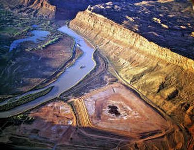 
This undated aerial photo provided by Grant County, Utah, shows the former Atlas Tailings pile, lower right, next to the Colorado River near Moab Utah. The Department of Energy announced Wednesday it will move this pile of radioactive uranium processing waste off the banks of the Colorado River.
 (File/Associated Press / The Spokesman-Review)