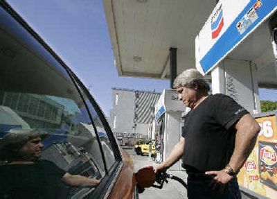 
Taxi driver Eugene Samsonov fills up gas at a Chevron station in San Francisco. Chevron Corp.'s third-quarter profit soared to $5 billion to easily surpass analysts' estimates, continuing the prosperous times in the oil industry. 
 (Associated Press / The Spokesman-Review)