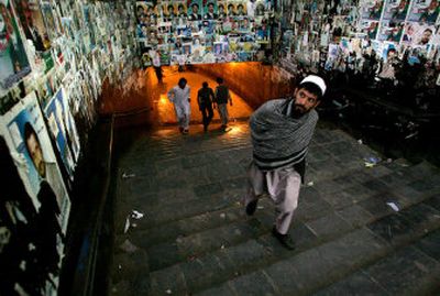 
A man looks at election campaign posters hanging on walls at the exit of an underground walkway Saturday in Kabul, Afghanistan. 
 (Associated Press / The Spokesman-Review)