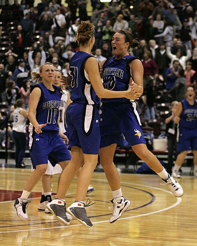 Coeur d’ Alene’s Kama Griffitts (10) celebrates with Whitney Heleker (30) and Sadie Simon (11) after Heleker hit winning shot in overtime to give the Vikings the 5A state championship this past winter.  (File / The Spokesman-Review)