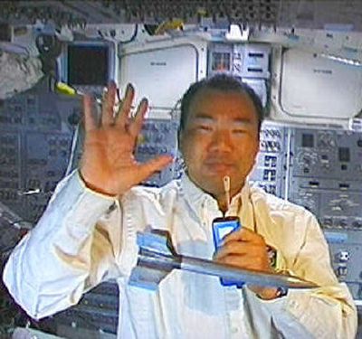 
Japanese astronaut Soichi Noguchi plays with a toy rocket and waves in this televised view from the aft flight deck of space shuttle Discovery on  Sunday. 
 (Associated Press / The Spokesman-Review)