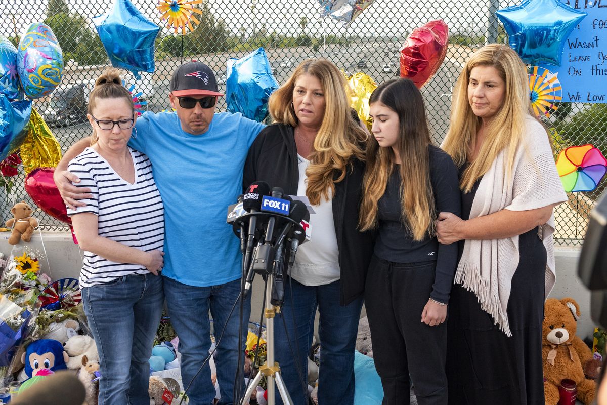 FILE - In this Tuesday, May 25, 2021, file photo, family members of 6-year-old Aiden Leos stand at a makeshift memorial on the Walnut Avenue overpass at the 55 Freeway in Orange, Calif., to announce that the reward for information leading to the suspects in the road-rage shooting death of Leos. Family members and friends tearfully remembered Leos, who was shot and killed in the incident on a Southern California freeway, at his memorial service on Saturday, June 5.  (Leonard Ortiz)