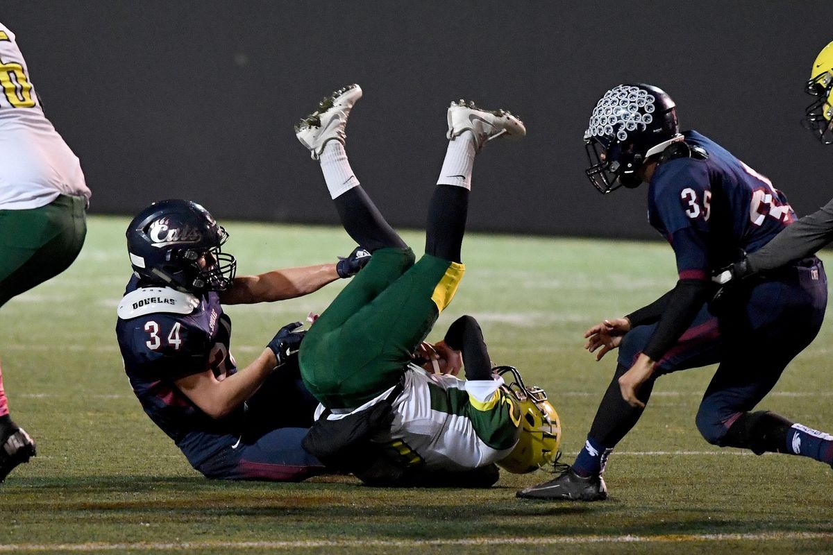 Shadle Park quarterback Carson Doyle (2) is sacked for a loss of 6-yards during first half of a GSL high school football game at Joe Albi Stadium, Thurs., Oct. 20, 2016. (Colin Mulvany / The Spokesman-Review)