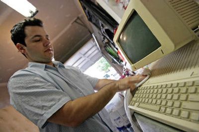 Collectors are taking a second look at obsolete computers such as Thomas Ballos' Apple IIc, shown in Ballos' garage in Ashburn, Va. These days people are holding on to their old desktops and laptops, turning yesteryear's outmoded computers into today's historic artifacts, giving them a growing value in the collectibles market.
(The Washington Post / The Spokesman-Review)