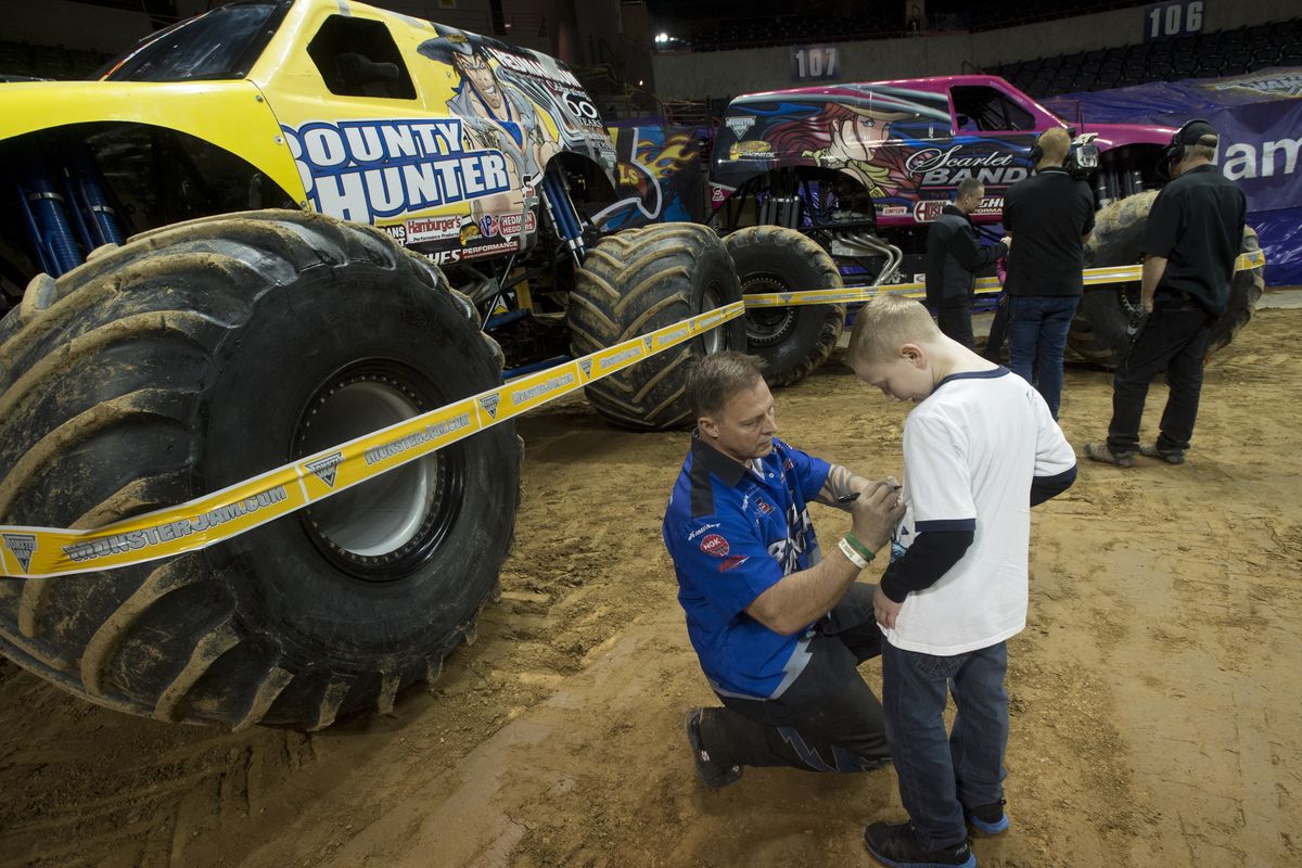 Jorden Altringer, 8, gets his T-shirt signed by Bounty Hunter driver Jimmy Creten during Party In The Pits on Saturday at the Spokane Arena. (Tyler Tjomsland)
