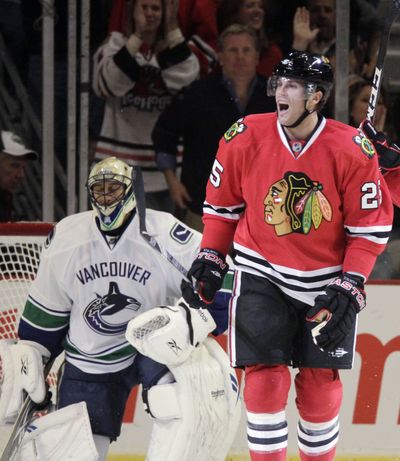 Chicago’s Viktor Stalberg, right, reacts after scoring against Vancouver’s Roberto Luongo in Wednesday’s NHL game.  (Associated Press)