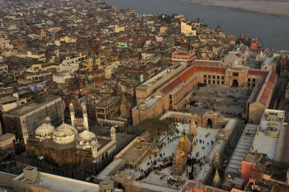 An Aerial view shows Gyanvapi mosque, left, and Kashiviswanath temple on the banks of the river Ganges in Varanasi, India, Dec. 12, 2021. A group of Hindus petitioned a local court seeking access to pray inside the mosque compound, saying they believe the Gyanvapi mosque in Varanasi, one of Hinduism’s holiest cities, was built on top of the ruins of a medieval-era temple and that the complex still houses Hindu idols and motifs, a claim that has been contested by the mosque authorities. (Rajesh Kumar Singh)