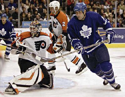 After 12 NHL seasons, Eric Lindros, right, has made his way to his favorite team.
(Associated Press / The Spokesman-Review)