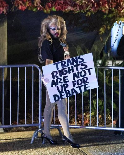 Vinny Torres, who performs as “Skinny Mocha,” holds a sign that says, “Trans rights are not up for debate.” Anti-transgender activists Chris Elston and Chloe Cole spoke at the Fisher Science building at Cal Poly in early December. Cole and other conservatives say transgender people regret gender-affirming surgery, but recent research says the vast majority do not.  (David Middlecamp/San Luis Obsipo Tribune/TNS)